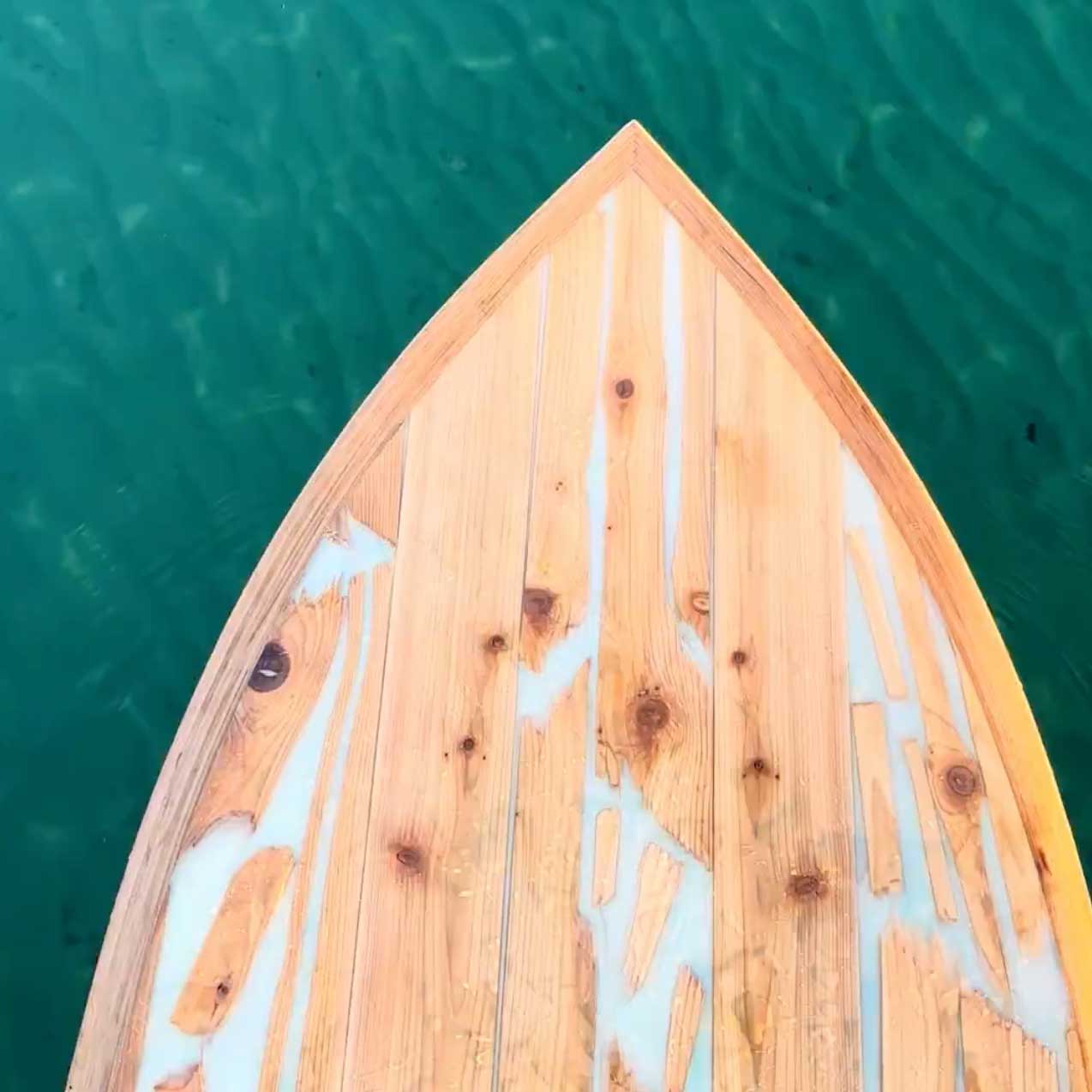 Wooden paddleboard on clear water